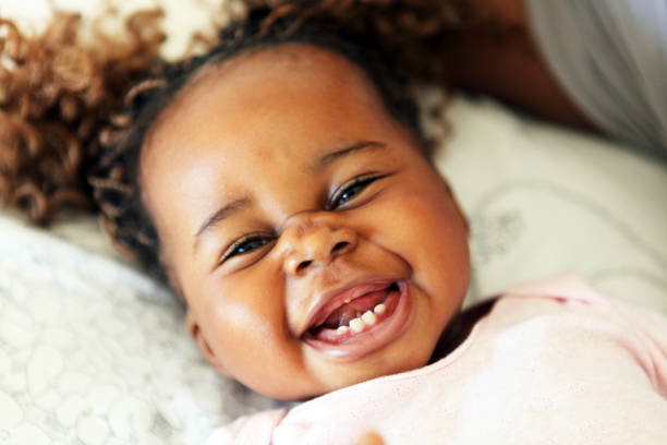 Happiness Cute African girl smiling at the camera baby teeth stock pictures, royalty-free photos & images
