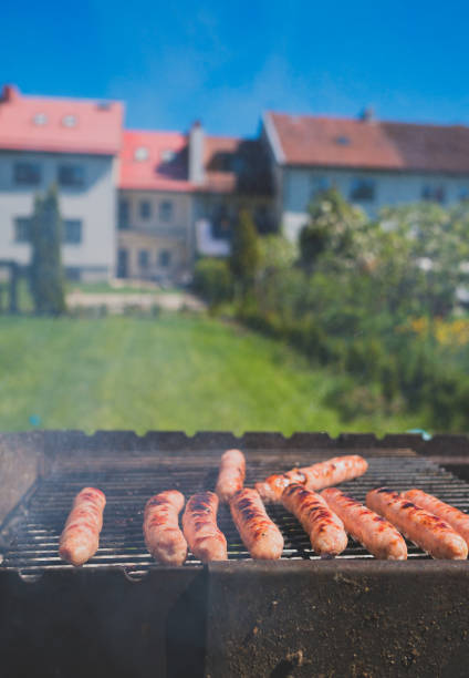 The grill season is open. Grilled sausages on backyard.