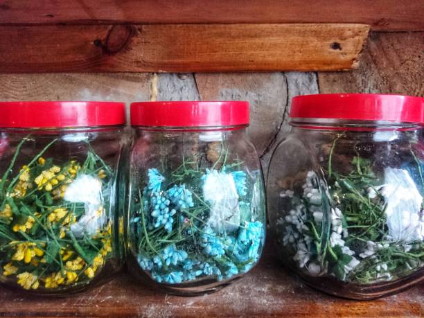 istock Artificial flowers in glass bottles for making wreaths. 1245090287