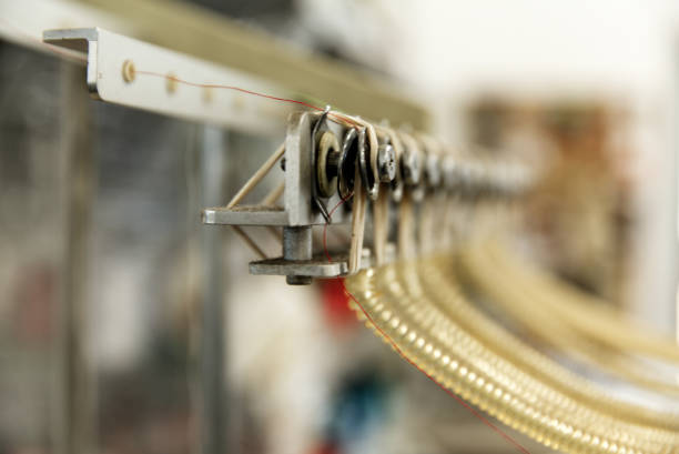 istock Thin red line that goes trough the threading on profesional embroidery machine 1245094939