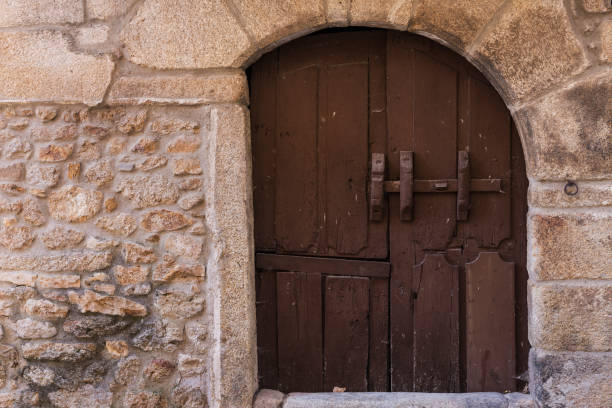 istock Old wooden door in stone facade 1245095475