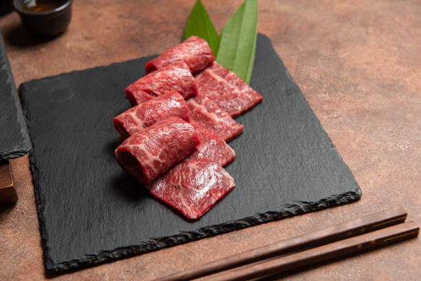 Fresh raw beef brisket slice set on the black marble dish rock. Fresh raw beef brisket slice set on the black marble dish rock. healthy and raw food concept mie prefecture photos stock pictures, royalty-free photos & images