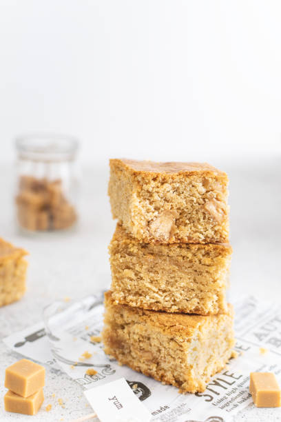 Close up of toffee caramel blondies, sweet pastry on light table Close up of toffee caramel blondies, sweet pastry on light table, copy space blondy stock pictures, royalty-free photos & images