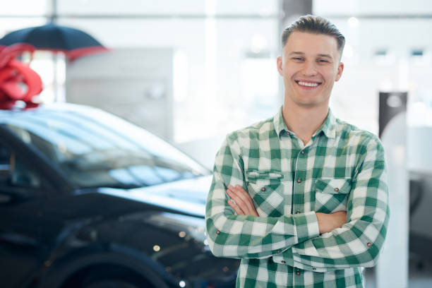istock Smiling man posing near car. 1245116849