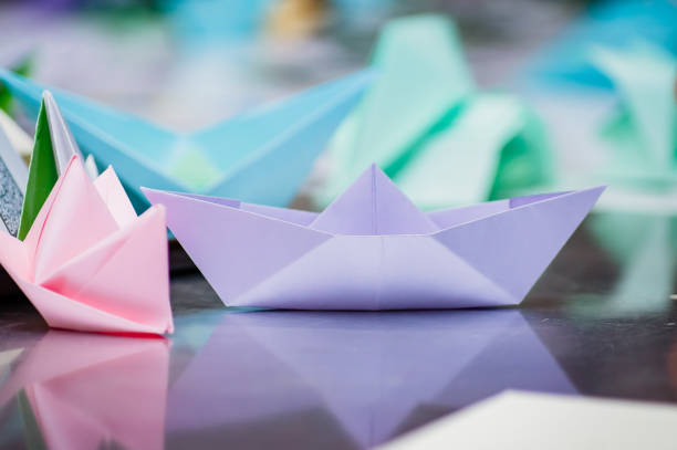 istock Several paper boats stand on the mirror surface. 1245117534