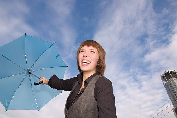 istock Smiling woman with umbrella on sky background 124511788