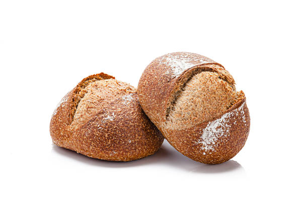 Two buns of brown bread isolated on white background. Predominant color is brown. High key DSRL studio photo taken with Canon EOS 5D Mk II and Canon EF 70-200mm f/2.8L IS II USM Telephoto Zoom Lens