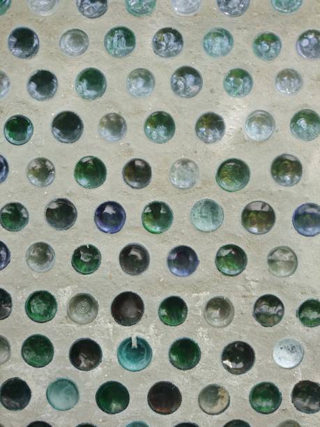 istock Creative wall made of old concrete filled glass bottles. 1245119788