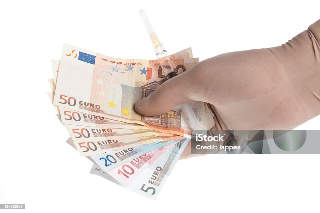 Doctors money Money and syringe in the hand of a doctor Clean Stock Photo