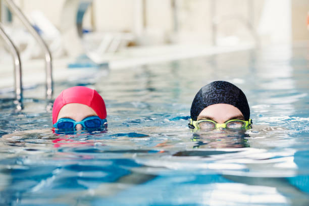 istock Siblings swim in a pool 1245130436