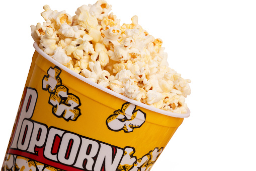 closeup of a bucket of popcorn on white background