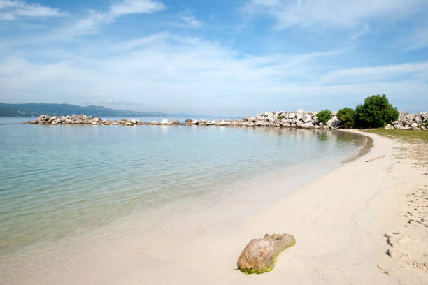 The empty beach with a wave breaker in Montego Bay resort town (Jamaica).