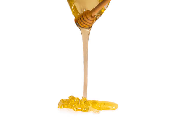 istock Dipper with honey on a white background. 1245147587