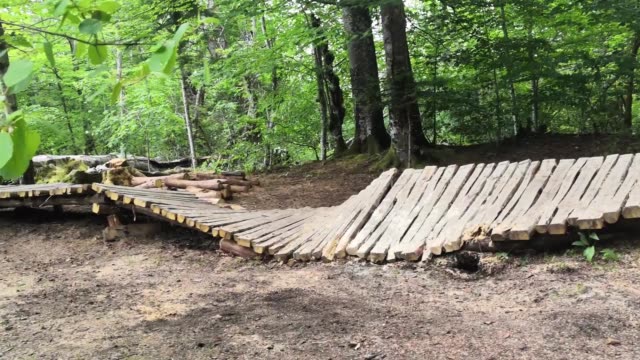 Wooden walk bridge in Croatian national park of Plitvice lakes ruined and destroyed. Closed path as time and weather breaks old wooden beams leading over water