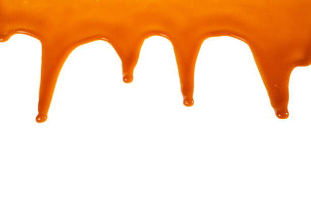 istock Background of flowing caramel sauce isolated on white. 1245148667