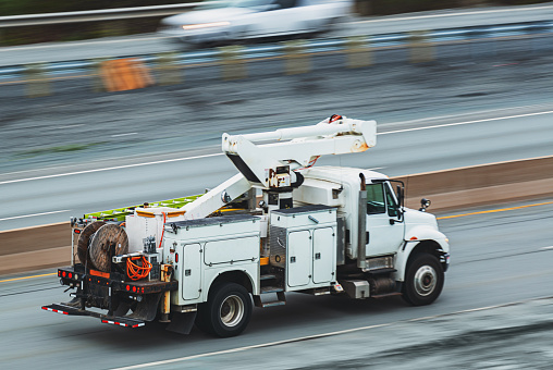 Panning with a power utility truck in evening light yielding motion blur.