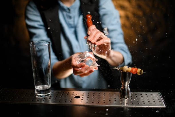 istock Close-up clean empty glass and metal jigger standing on bar counter. 1245155346