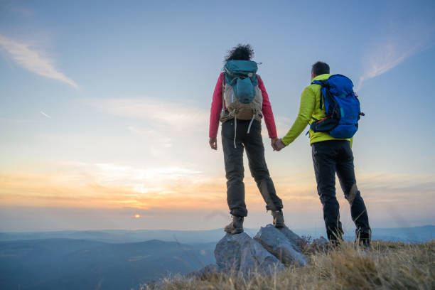 istock Man and woman standing on mountain 1245161990