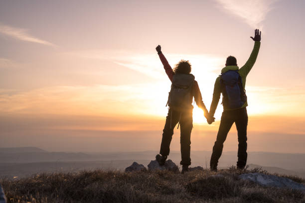 istock Man and woman standing on mountain 1245161991
