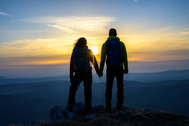 istock Man and woman standing on mountain 1245162003