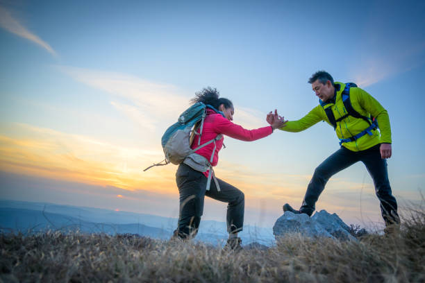 istock Man and woman hiking on mountain 1245162008
