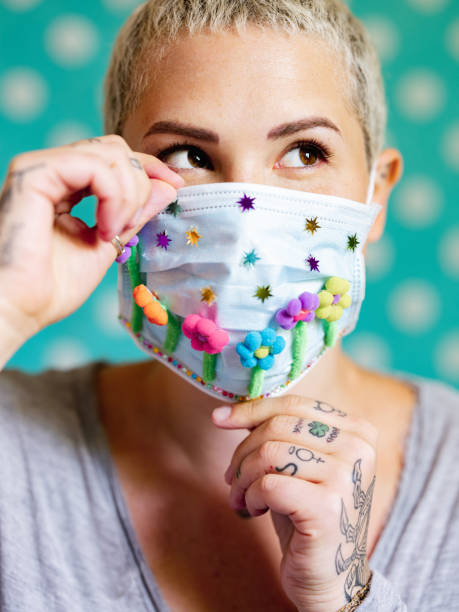istock Young woman with artsy face mask 1245163117