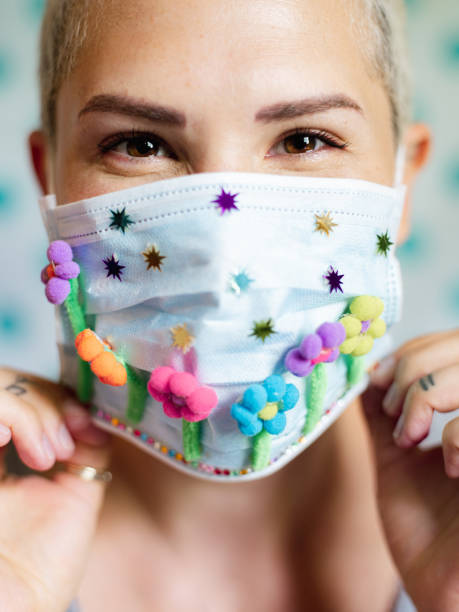 istock Young woman with artsy face mask 1245165800