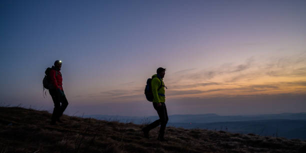 istock Man and woman hiking on mountain 1245181875