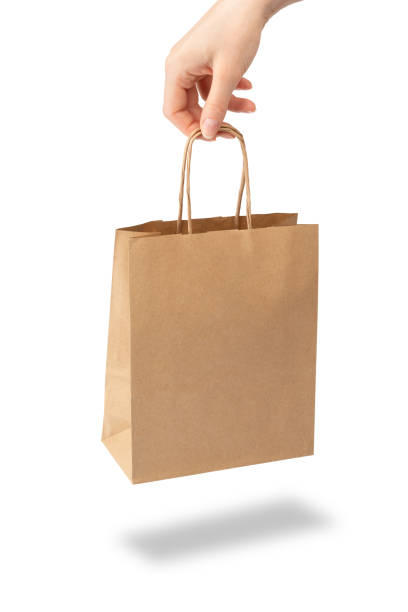 istock Hand holding a paper bag. Close up. Isolated on white background. 1245188958