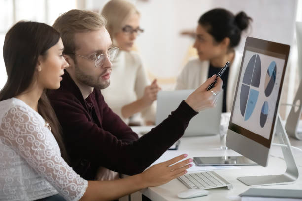 istock Motivated coworkers working on presentation in office. 1245196356