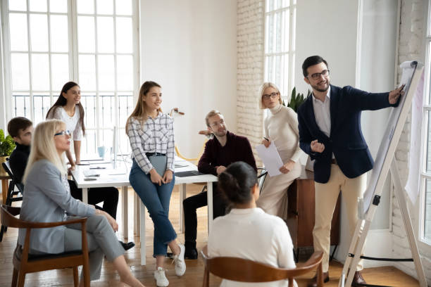 istock Smiling middle aged and young focused managers listening to speaker. 1245196911