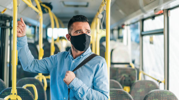 istock Men with protective face mask traveling with bus, during COVID-19 1245226380