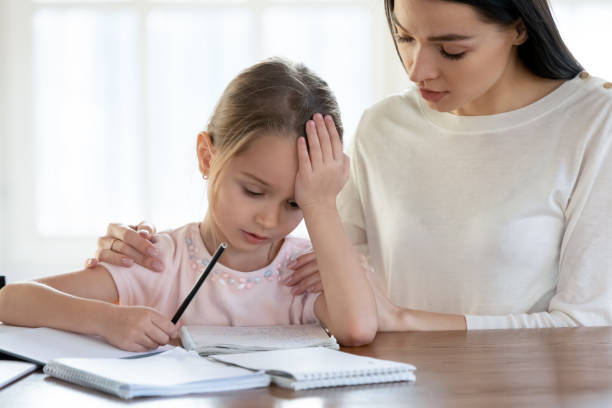 istock Loving mom help upset little daughter with studying 1245229329