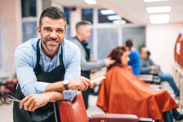 Hairdresser stands in a hairdressing studio Hairdresser stands in a hairdressing studio cutting hair photos stock pictures, royalty-free photos & images