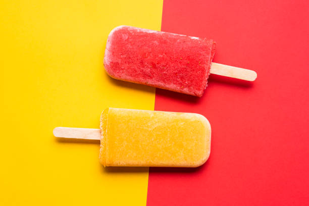 istock Ice cream popsicles top view. Mango and strawberry icecream 1245237110