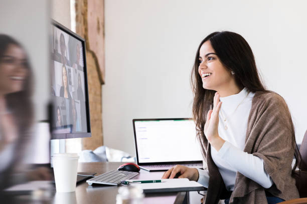 istock Young business owner waves goodbye after video meeting 1245239341