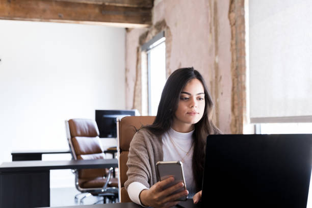 istock Small business owner uses phone and laptop for work 1245239349