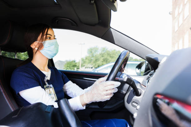 istock Nurse drives to work wearing protective equipment 1245240507