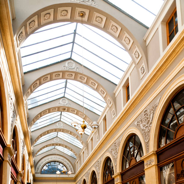 La galerie Vivienne (Vivienne gallery) is the most beautiful covered passage in Paris, near Palais Royal, Comédie Française, Grands boulevards et Grands magasins. It's a small street covered built in the 19th century, with a glass roof which is a protection against bad weather, mud, for doing shopping. No people, no tourists, during Covid19 virus pandemic in Europe, few days after the lockdown. Paris in France, May 16, 2020.