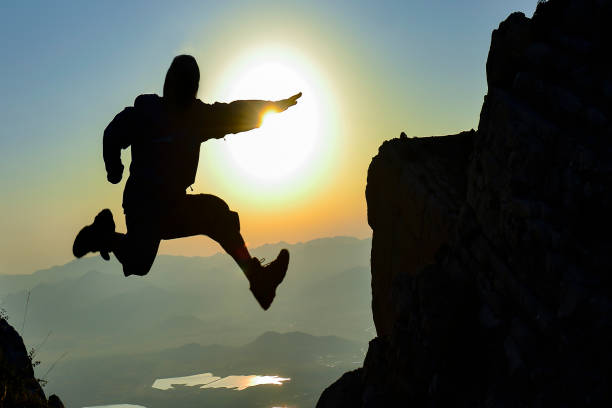 istock peak mountains, target success, tenacious people and creative energetic jump 1245248238