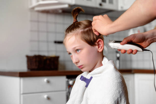 istock Father cutting son's hair at home. 1245264235