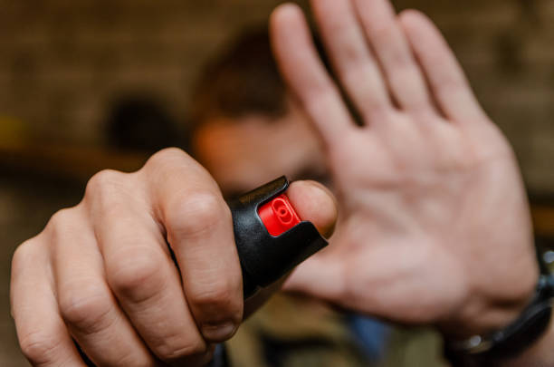 istock Man holding pepper spray for self defense close up 1245266427