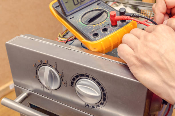 istock master man repairs microwave oven in the workshop 1245269931