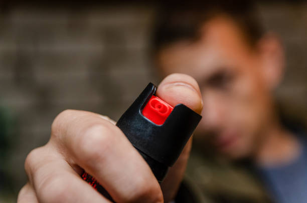 istock Man holding pepper spray for self defense close up 1245270486