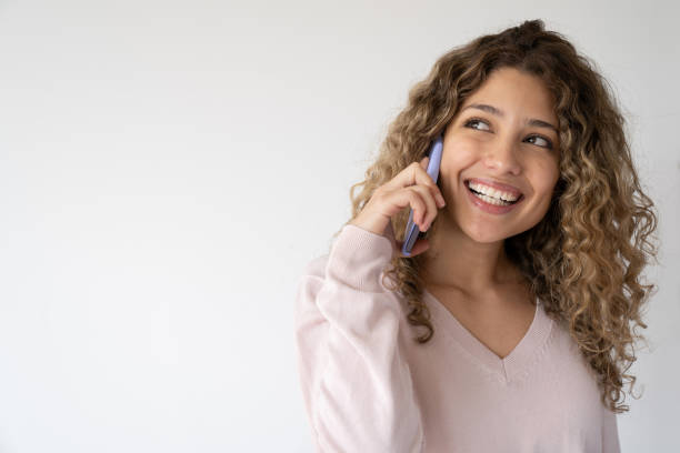 istock Happy young woman talking on her cell phone 1245271081