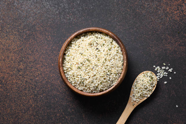 istock Kernels hemp in wooden bowl on brown.View from above. 1245277508