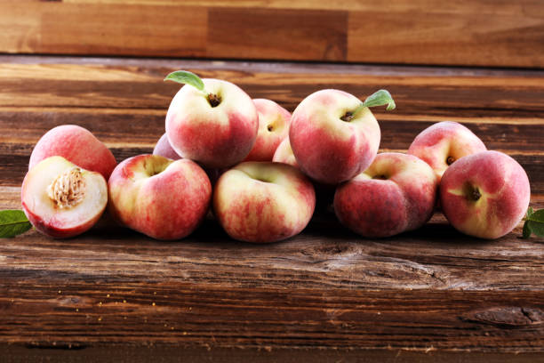 istock A group of ripe peaches on wooden table 1245279682