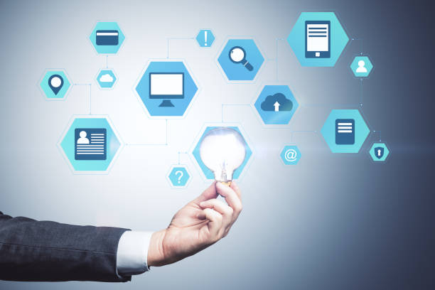 istock Hand holding lamp and business interface hologram. 1245280259