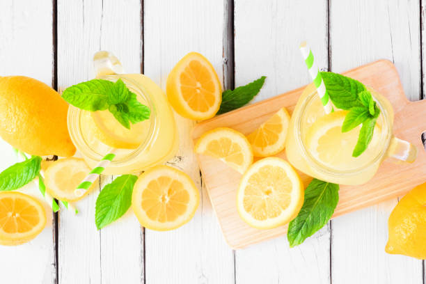 istock Summer lemonade above view table scene on a white wood background 1245281919