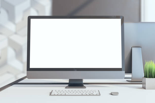 istock Blank white computer monitor screen on table in office 1245283553